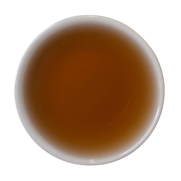 Steeped cup Dragon's Shadow Ripe Shu Puer tea cake